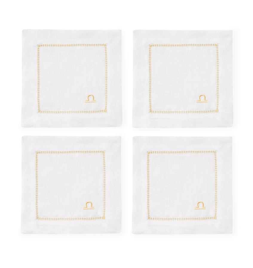 https://www.sferra.com/cdn/shop/products/SFERRA-SEGNI-COCKTAIL-NAPKINS--WHITE-LIBRA-SILO_v2_1024x1024.jpg?v=1631122126